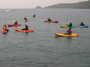 selection of sit on top kayaks on the sea.Bouley bay,Jersey