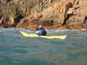 Sea kayaking along the cliffs at Portelet Jersey