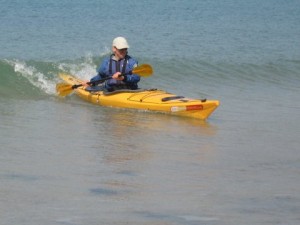 sea kayak landing in small surf